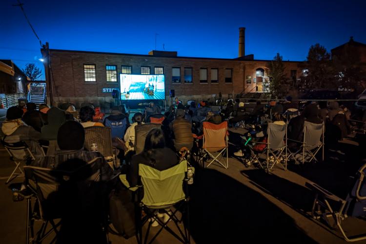 a large groups of people at an outdoor screening of Crowdsourced Star Wars