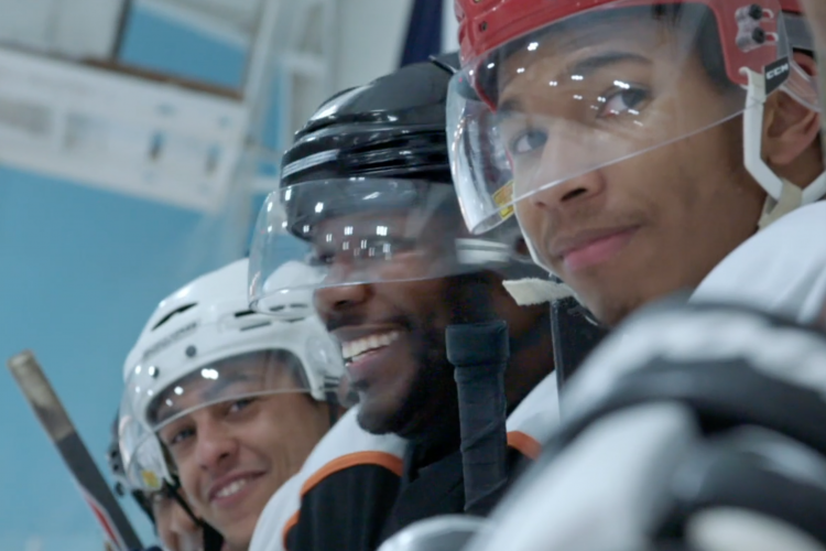 Hockey players watching the game, still from