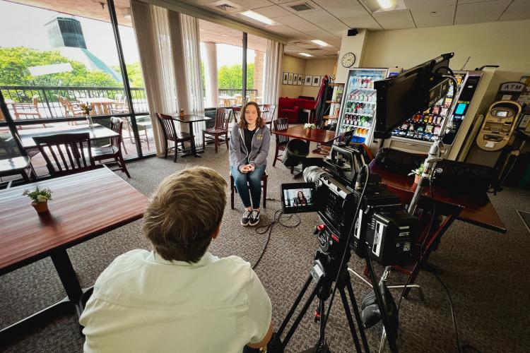 LEAP student in foreground being interviewed by Marcy Webster at the Overlook Cafe.