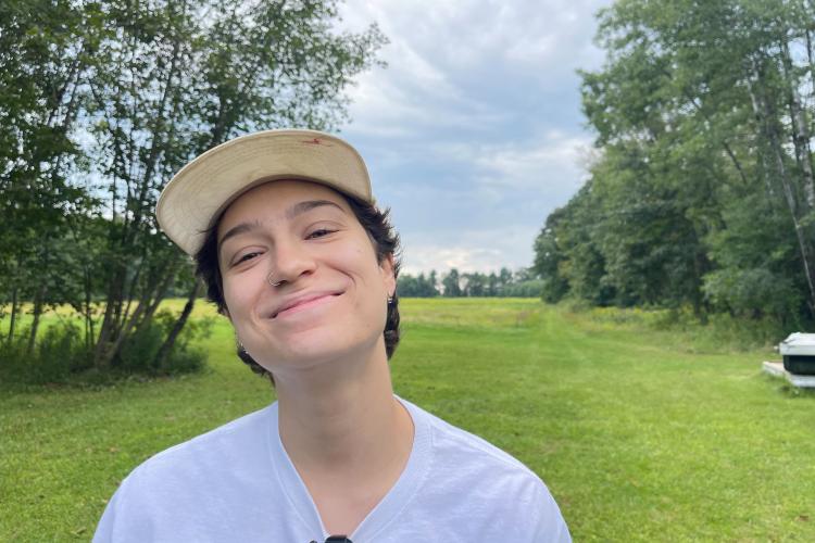 A photo of Gabby Valdivieso smiling in a field