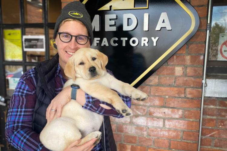 Jess holding Willow as a puppy outside the Media Factory