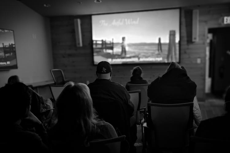 A screening of a film, with people watching