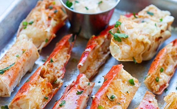 close up of king crab legs on a tray with butter