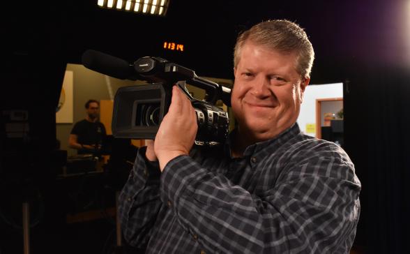 person filming with a videocamera