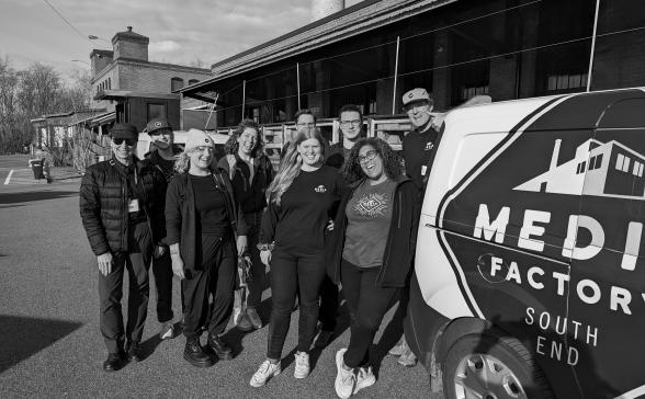 A group of staff next to the van outside the Media Factory
