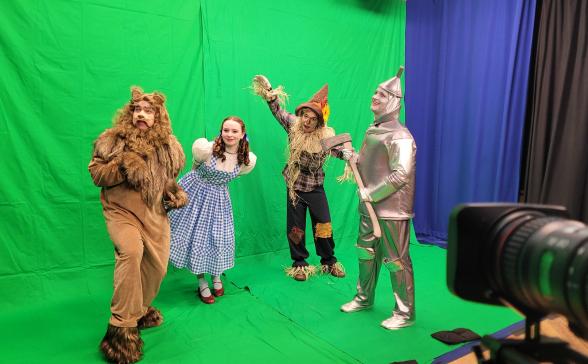 Characters from The Wizard of Oz in front of a green screen