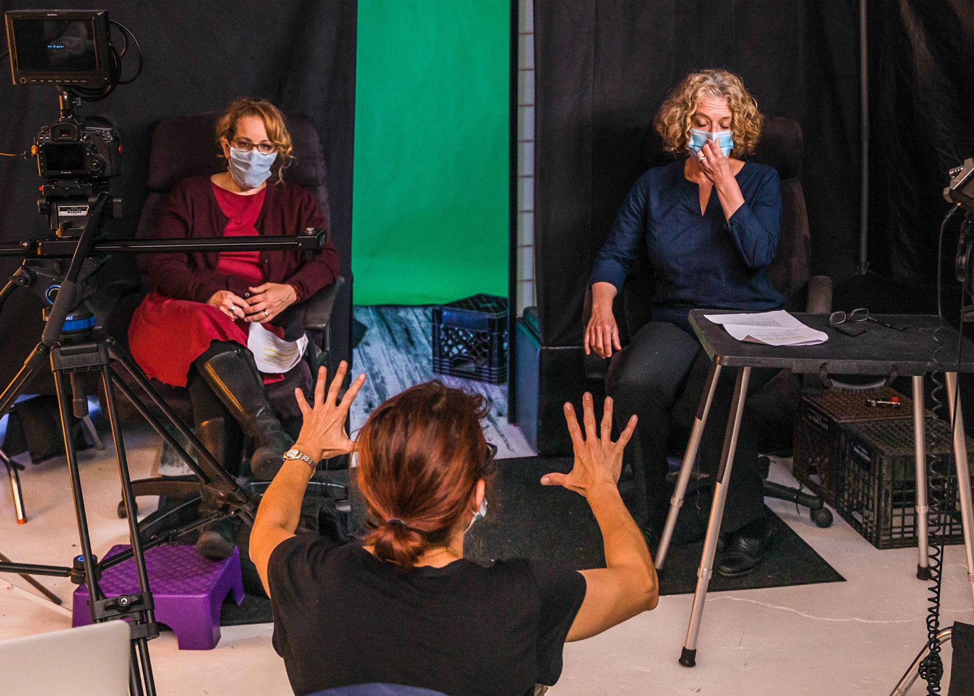 On the set of the Plane Home, director Jude Domski coaches two masked actors