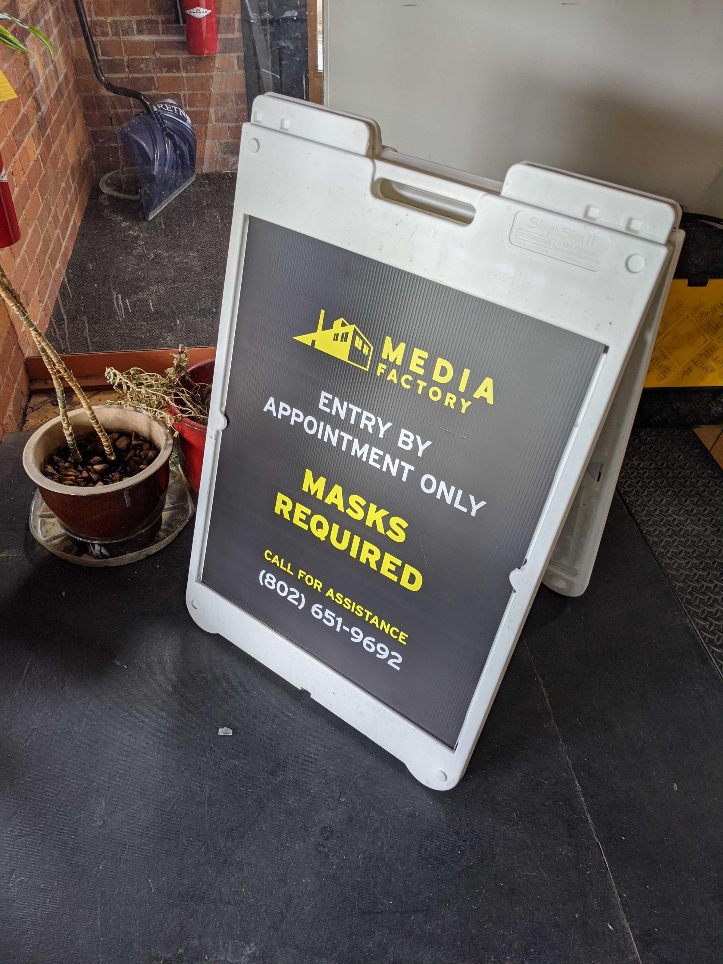 Sign board that says "Entry by Appointment Only. Masks Required"