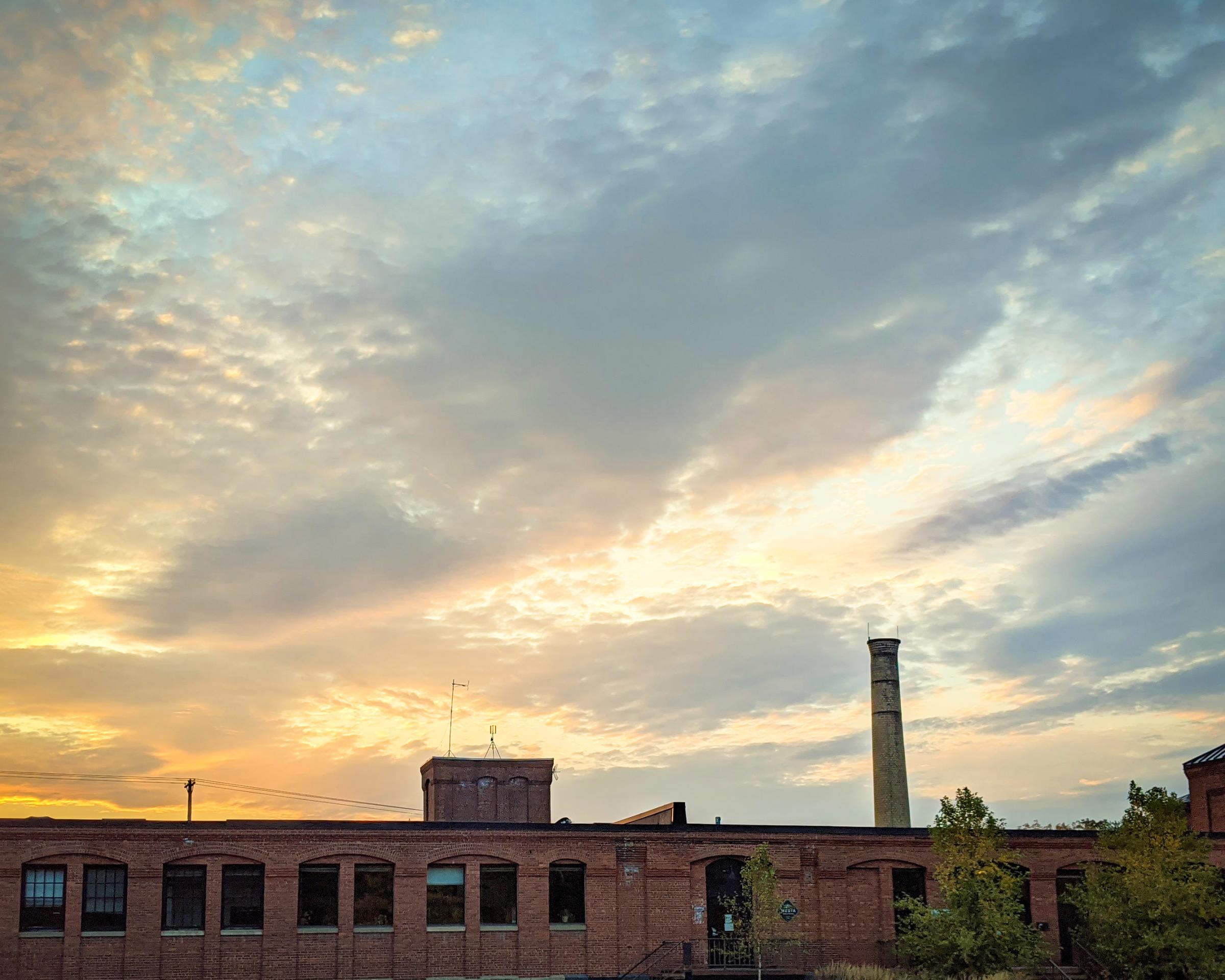 The Media Factory at sunset, a large swath of blue and yellow sky