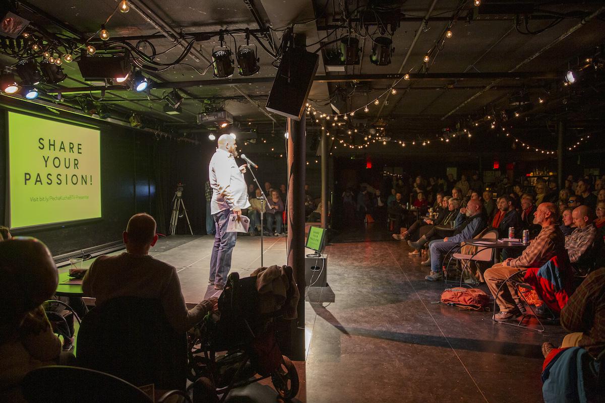 Chris Dissinger on stage at Pecha Kucha in 2019.