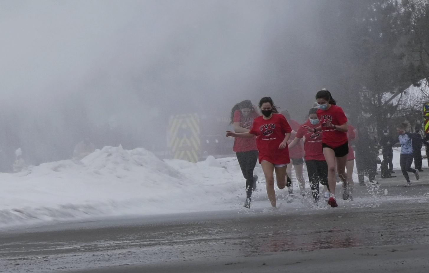CVU students run towards the lake for the Penguin Plunge.