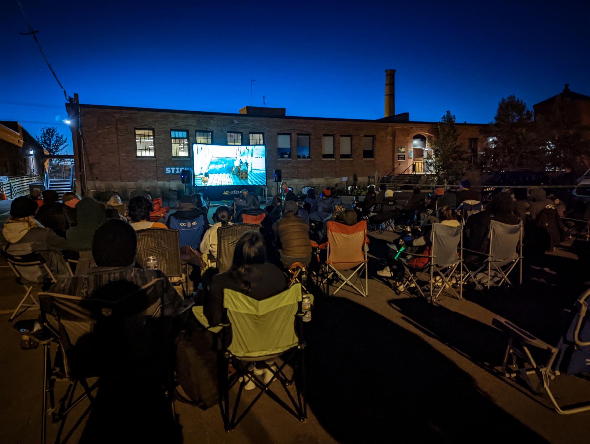 a large groups of people at an outdoor screening of Crowdsourced Star Wars