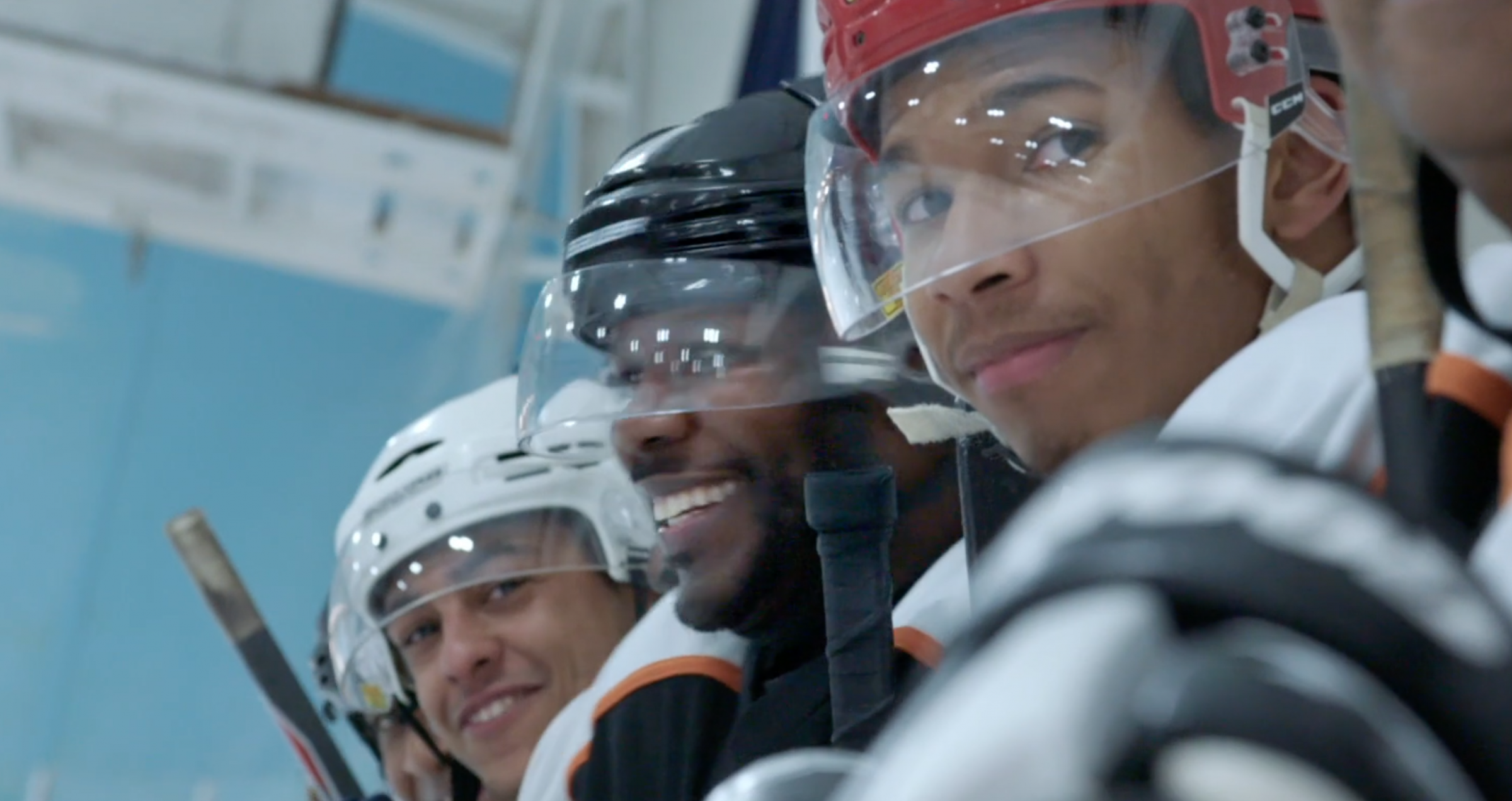 Hockey players watching the game, still from