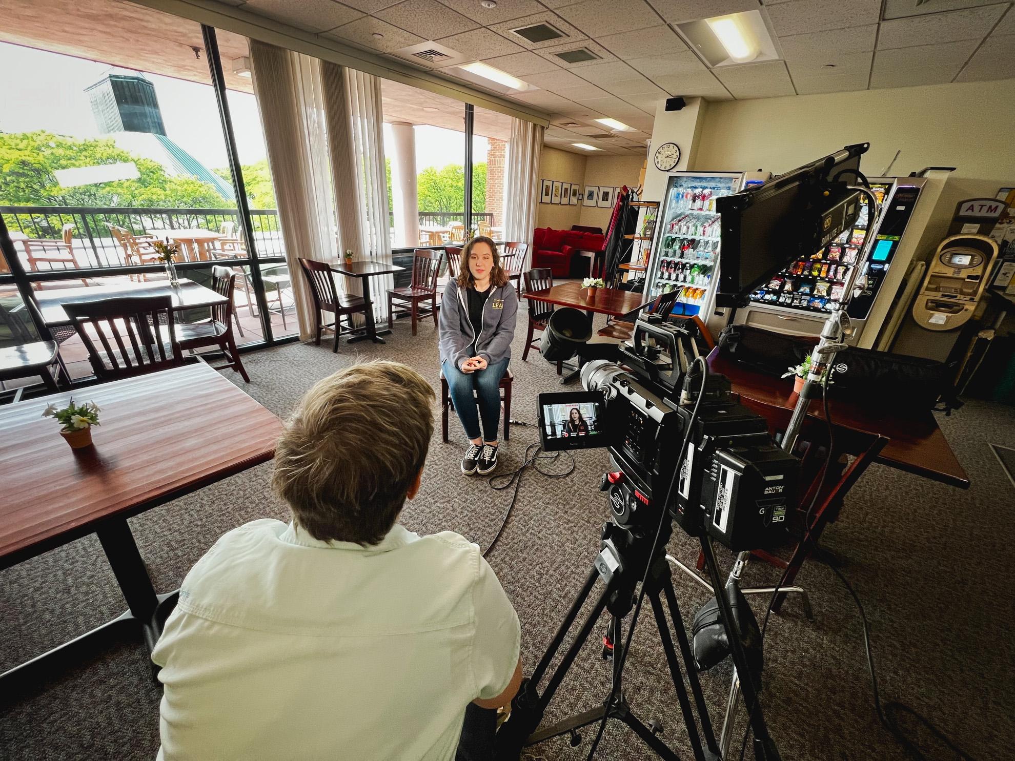 LEAP student in foreground being interviewed by Marcy Webster at the Overlook Cafe.
