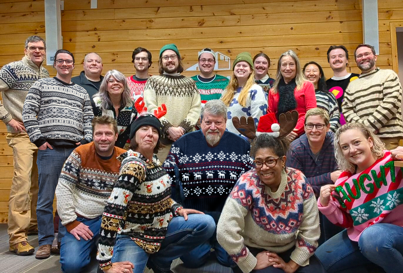 The Media Factory staff wearing colorful sweaters in a group photo.