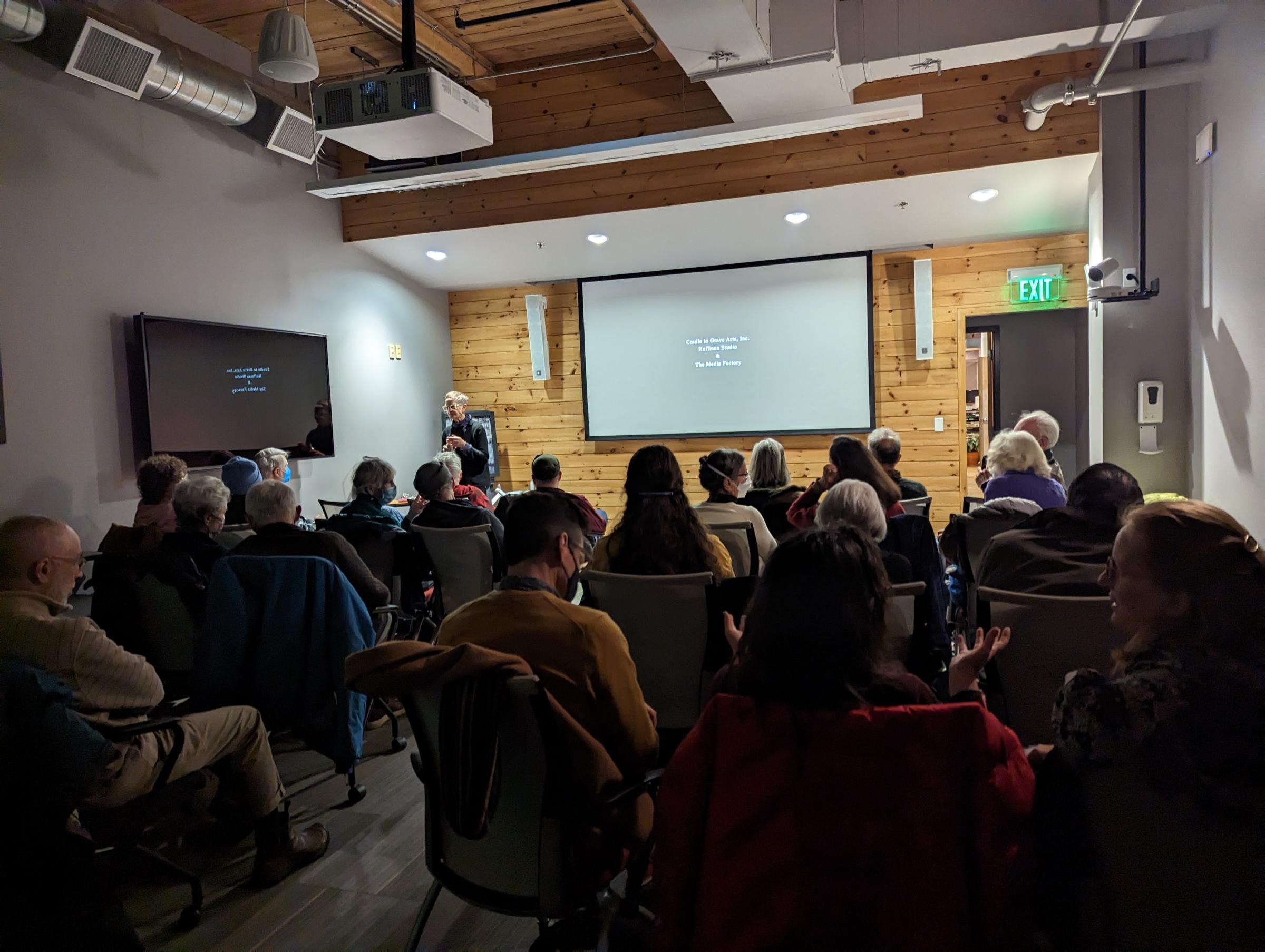 An audience looking at a screen in the Media Factory Classroom