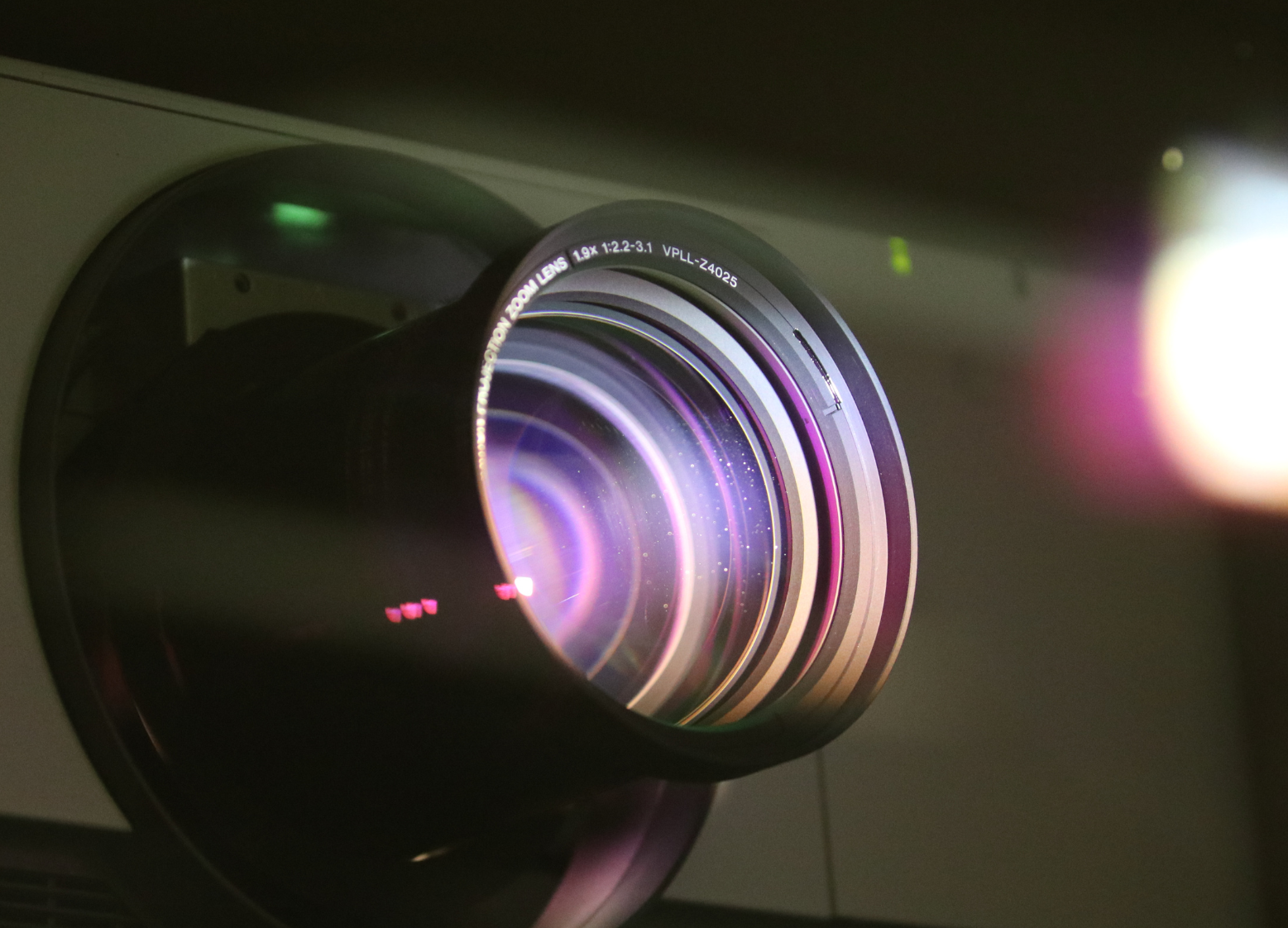 a projector lens close up, with a purple glow