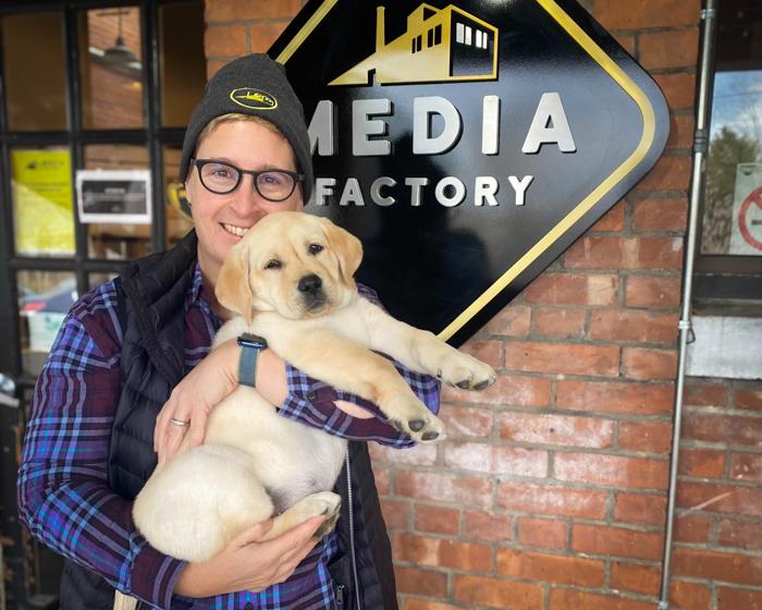 Jess holding Willow as a puppy outside the Media Factory